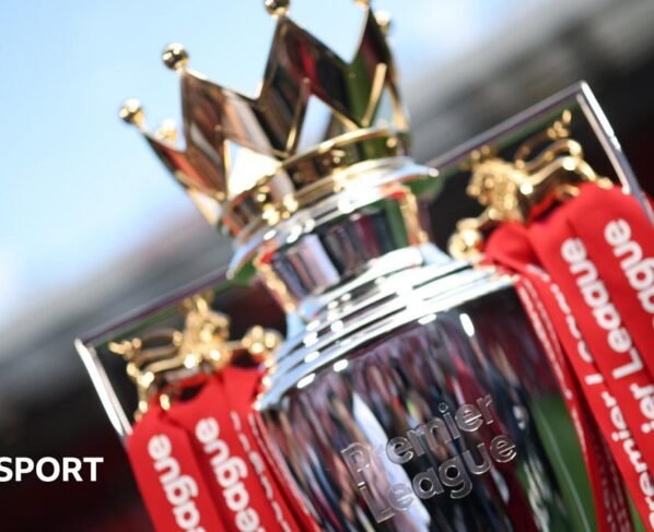 The Premier League trophy dressed in red ribbons