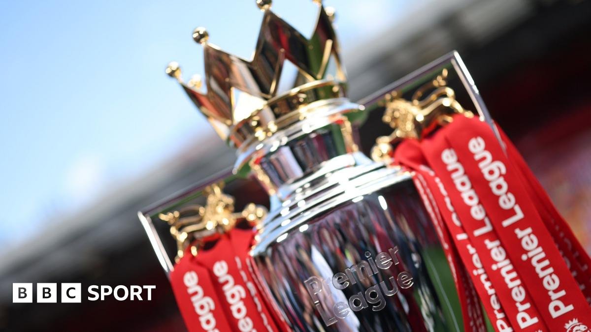 The Premier League trophy dressed in red ribbons